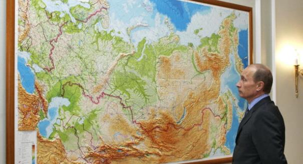 NOVO-OGARYEVO, RUSSIAN FEDERATION:  Russian President Vladimir Putin looks at a map in his country at his residence of Novo-Ogaryevo outside Moscow, 11 August 2006. Russian President Vladimir Putin and Iranian President Mahmud Ahmadinejad have discussed the situation in the Middle East in follow up to their telephone conversation in late July, the Kremlin press service reported on Friday. AFP PHOTO / ITAR-TASS POOL / PRESIDENTIAL PRESS SERVICE  (Photo credit should read DMITRY ASTAKHOV/AFP/Getty Images)